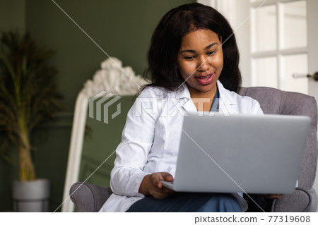 telehealth with virtual afro American doctor appointment and online therapy session. Black doctor online conference 77319608