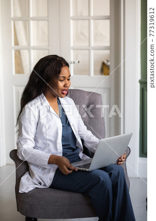 telehealth with virtual afro American doctor appointment and online therapy session. Black doctor online conference 77319612