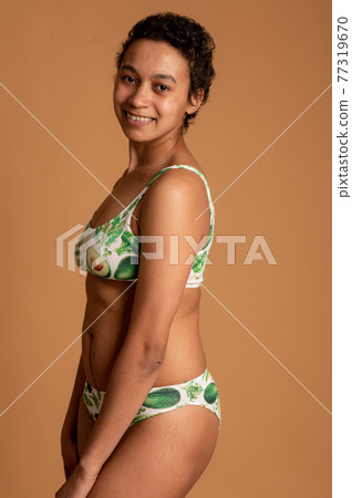 mulatto girl in lingerie posing on a pink background. body positive mulatto girl in lingerie posing on a pink background. body positive 77319670