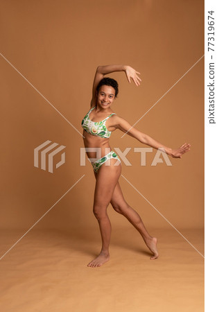 mulatto girl in lingerie posing on a pink background. body positive mulatto girl in lingerie posing on a pink background. body positive 77319674