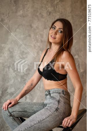 Beautiful woman in beige swimsuit on pink background Beautiful woman in beige swimsuit on pink background 77319675