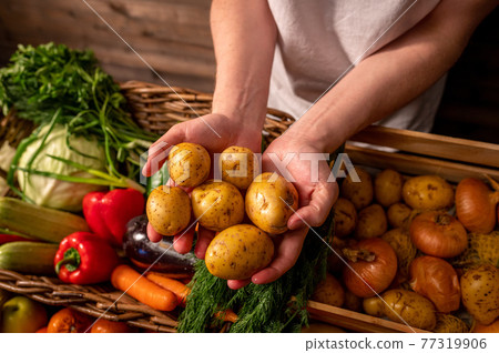 Assortment of fresh vegetables and fruits on wooden table 77319906