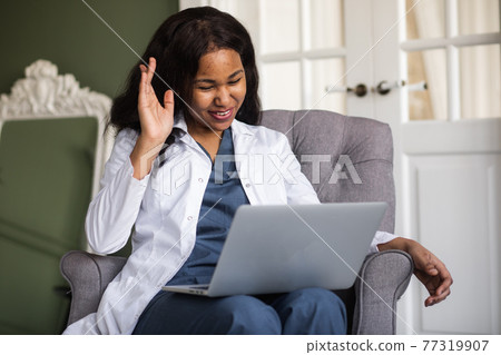 telehealth with virtual female doctor appointment and online therapy session. Black female doctor online conference  77319907