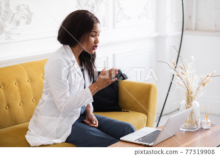 telehealth with virtual female doctor appointment and online therapy session. Black female doctor online conference  77319908