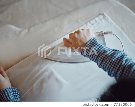 Woman ironing Woman ironing 77320066