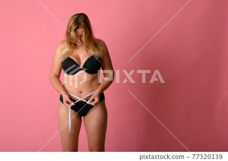 girl wearing black bikini measures the size of the waist girl wearing black bikini measures the size of the waist 77320139