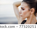 Yoga on a beach. Fitness model exercising outdoors. Concept of healthy lifestyle. 77320251