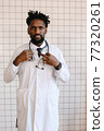 close-up portrait of black doctor smiling and looking at camera 77320261