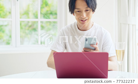 Men teleworking worcation working in a refreshing room Men teleworking worcation working in a refreshing room 77322237