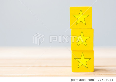 wooden blocks with the star symbol. Customer reviews, feedback, rating, ranking and service concept. 77324944