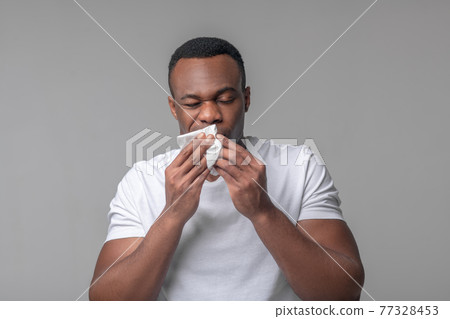 Unhappy man with handkerchief near nose Unhappy man with handkerchief near nose 77328453