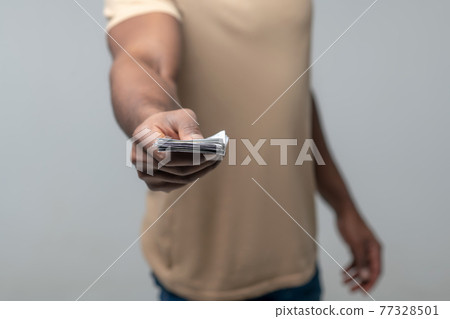 Male Hand With Banknotes Outstretched Forward Stock Photo