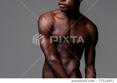 Nude lean young African man body in studio isolated gray background Nude lean young African man body in studio isolated gray background 77328951