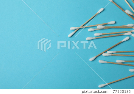 Cotton swabs on blue background, space for text Cotton swabs on blue background, space for text 77330185