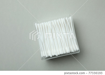 Plastic box with cotton swabs on light gray background 77330193