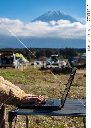 Women's hands doing remote work at the foot of Mt. Fuji Women's hands doing remote work at the foot of Mt. Fuji 77331341