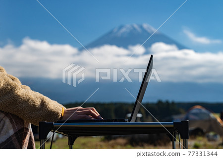 Women's hands doing remote work at the foot of Mt. Fuji Women's hands doing remote work at the foot of Mt. Fuji 77331344