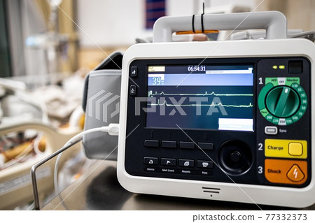 Monitor screen for medical defibrillator or emergency heart pump,showing vital signs,heart rate,slow beating pulse of a dying coma patient in a hospital ICU room or deaths from Coronavirus COVID-19 Monitor screen for medical defibrillator or emergency heart pump,showing vital signs,heart rate,slow beating pulse of a dying coma patient in a hospital ICU room or deaths from Coronavirus COVID-19 77332373