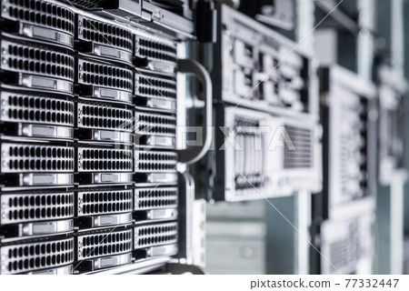 Cluster of data storage hard drives inside server room 77332447