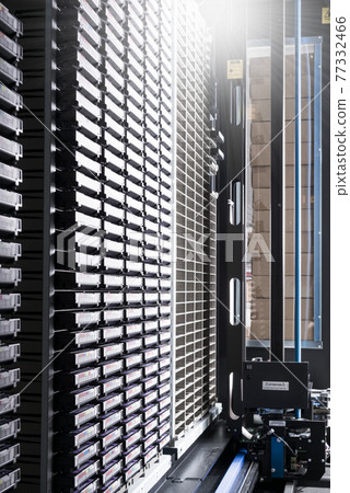 cluster of hard drives stacked inside data storage cabinet 77332466