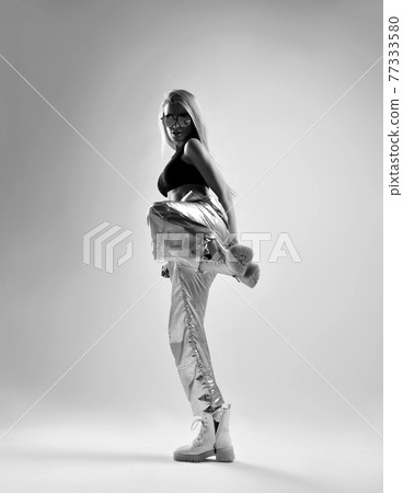 Black and white portrait of sporty woman, hip-hop 77333580