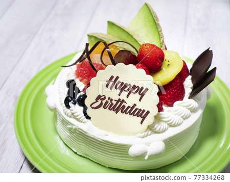 Celebration whole cake with plenty of fruit and cream [Happy Birthday] with English letters 77334268