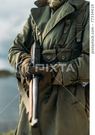 Soldier Of USA Infantry Of World War II Holds Submachine Weapon In Hands 77334419