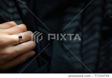 white gold diamond ring isolated on black fabric background white gold diamond ring isolated on black fabric background 77334744