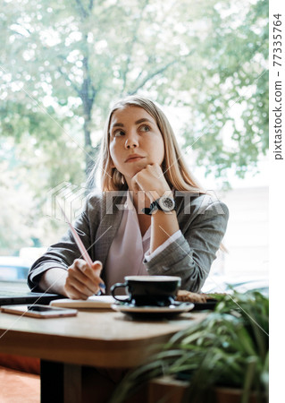 Thoughtful young woman, student girl think at workplace at cafe. Professional content creator thinking about project, student search new idea inspiration in office cafe Thoughtful young woman, student girl think at workplace at cafe. Professional content creator thinking about project, student search new idea inspiration in office cafe 77335764