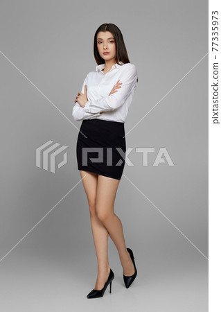 beautiful business woman in white shirt and skirt beautiful business woman in white shirt and skirt 77335973