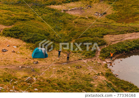 Tourists near Lake Brebeneskul in the Carpathians, trails to the lake. Tourists near Lake Brebeneskul in the Carpathians, trails to the lake. 77336168