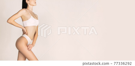 Beautiful slim tanned woman in underwear isolated over light background. Flyer Beautiful slim tanned woman in underwear isolated over light background. Flyer 77336292