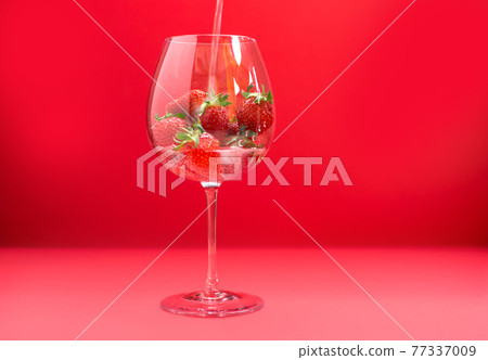 Bright juicy selected strawberries in a large glass with soda. Bright juicy selected strawberries in a large glass with soda. 77337009