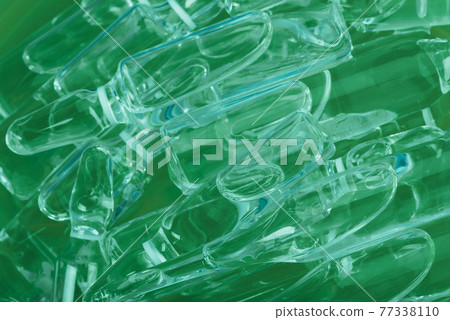 Glass medical ampoule vial for injection. Medicine is liquid sodium chloride with of aqueous solution in ampulla. Close up. Bottles ampule multicolor. 77338110