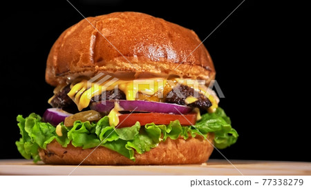 Craft burger is cooking on black background. Consist: sauce, lettuce, tomato, red onion, pickle, cheese, bacon, air bun and marbled meat beef. Craft burger is cooking on black background. Consist: sauce, lettuce, tomato, red onion, pickle, cheese, bacon, air bun and marbled meat beef. 77338279