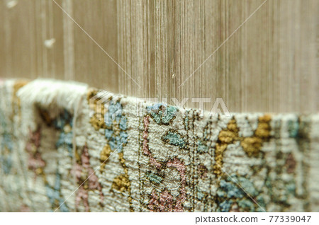 Weaving and manufacturing of handmade carpets. Carpet in the making process Weaving and manufacturing of handmade carpets. Carpet in the making process 77339047