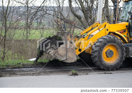 excavator works on road repair 77339507