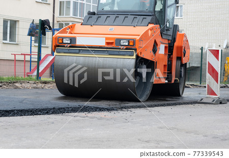 repair of an asphalt road with fresh asphalt 77339543