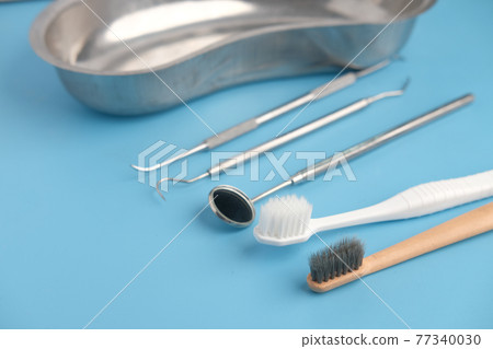 dental equipment and tooth brush on blue background  77340030