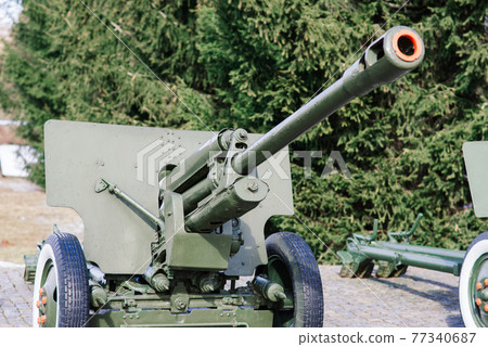 View of the russian cannons and howitzers in a park. Military museum outdoors View of the russian cannons and howitzers in a park. Military museum outdoors 77340687