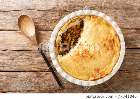 Canadian Pate Chinois pie with ground beef, corn and mashed potatoes close-up in a baking dish. Horizontal top view 77341846