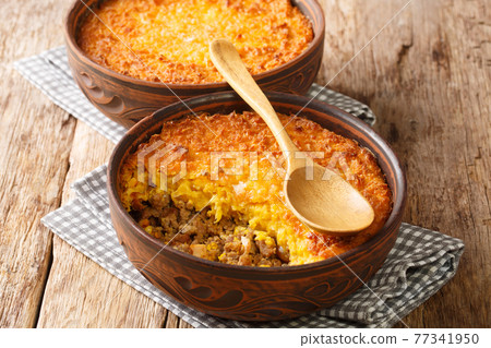 Chilean shepherds pie, pastel choclo spiced ground beef with a pureed corn crust closeup in the pots. Horizontal Chilean shepherds pie, pastel choclo spiced ground beef with a pureed corn crust closeup in the pots. Horizontal 77341950