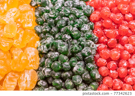 Tricolor composition of candied cherries and apricots yellow, green and red colors Tricolor composition of candied cherries and apricots yellow, green and red colors 77342623