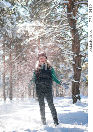 Woman in snowy forest in winter time. Woman in snowy forest in winter time. 77343450