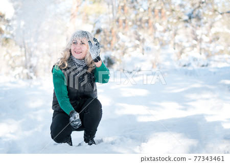 Person plays with snow outdoor. Person plays with snow outdoor. 77343461