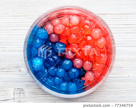 red and blue tapioca bubbles in glass bowl on gray red and blue tapioca bubbles in glass bowl on gray 77346759