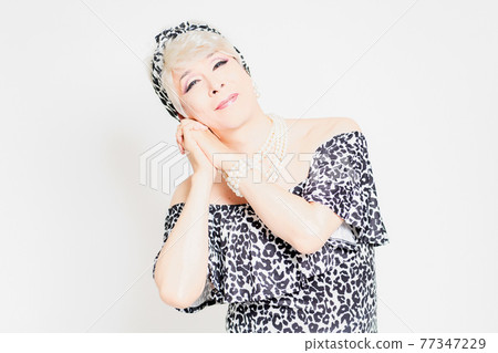 Drag queen standing in front of a white background and making a request gesture Drag queen standing in front of a white background and making a request gesture 77347229