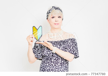 Drag queen with a beginner mark standing in front of a white background Drag queen with a beginner mark standing in front of a white background 77347780