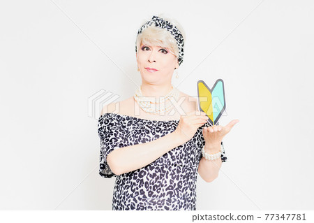 Drag queen with a beginner mark standing in front of a white background Drag queen with a beginner mark standing in front of a white background 77347781