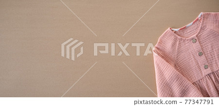 Muslin Eco Friendly Clothing, Organic Muslin Clothes. Natural tones dresses on beige recycled cardboard background Muslin Eco Friendly Clothing, Organic Muslin Clothes. Natural tones dresses on beige recycled cardboard background 77347791